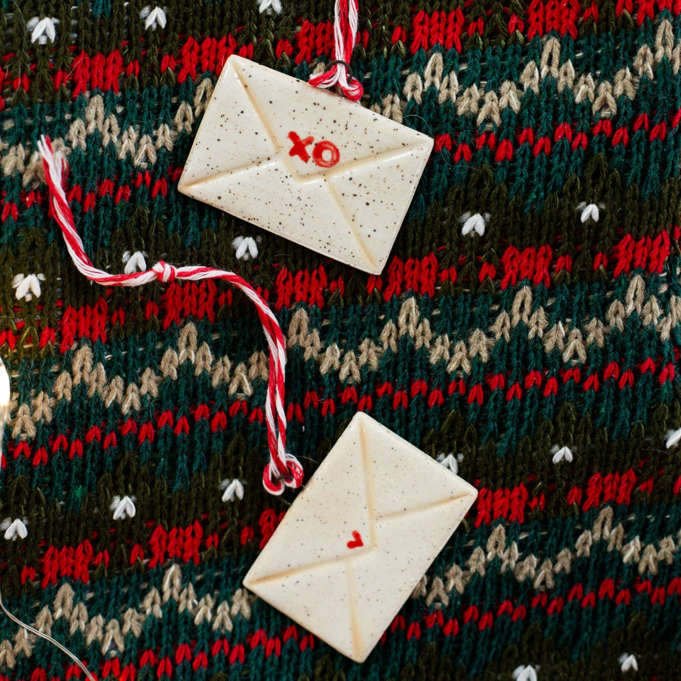 Decorative envelopes with 'XO' on a patterned fabric background