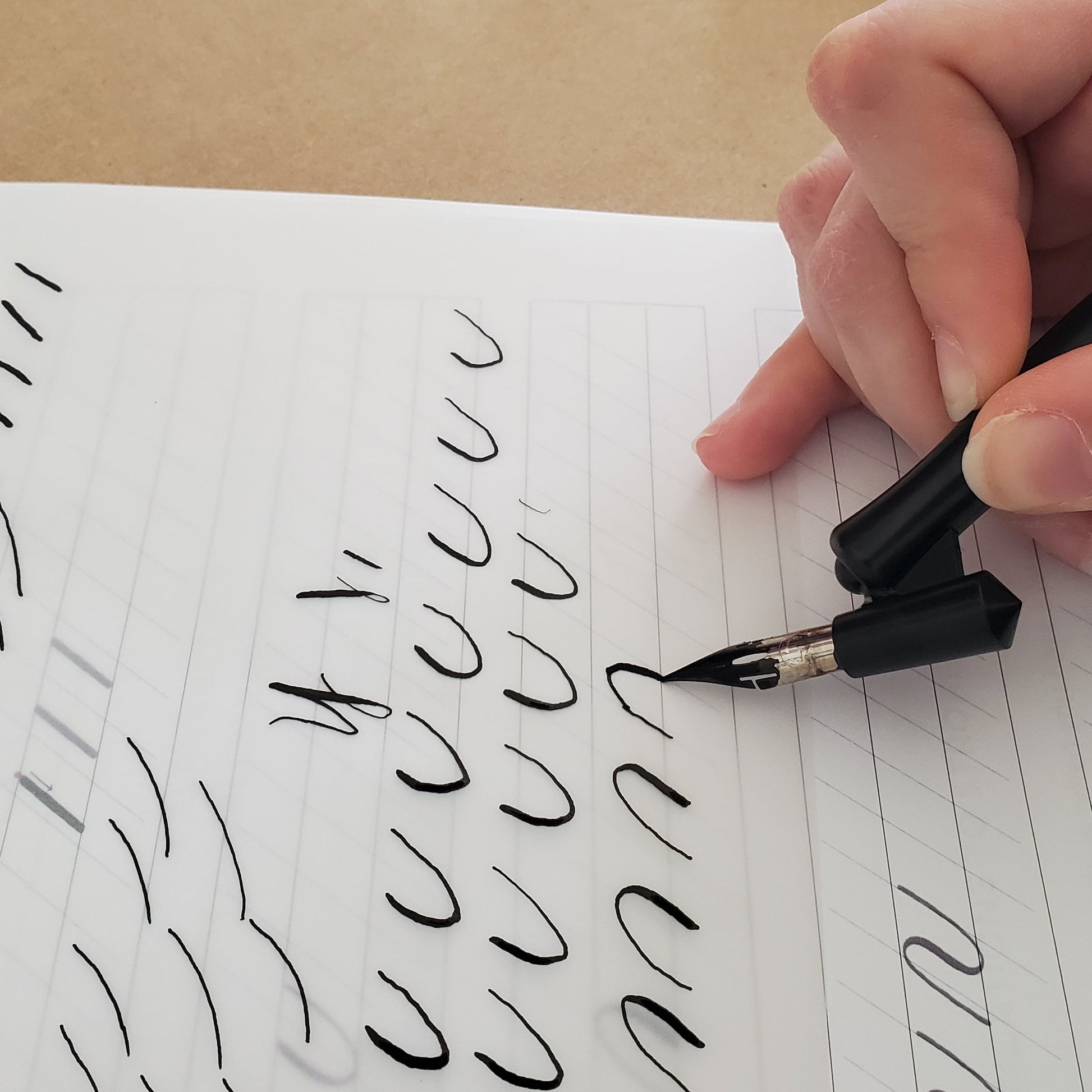 Hand writing on a piece of paper with a pen