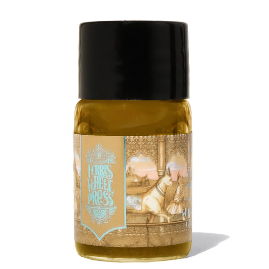 Bottle with a black cap and gold label on a white background