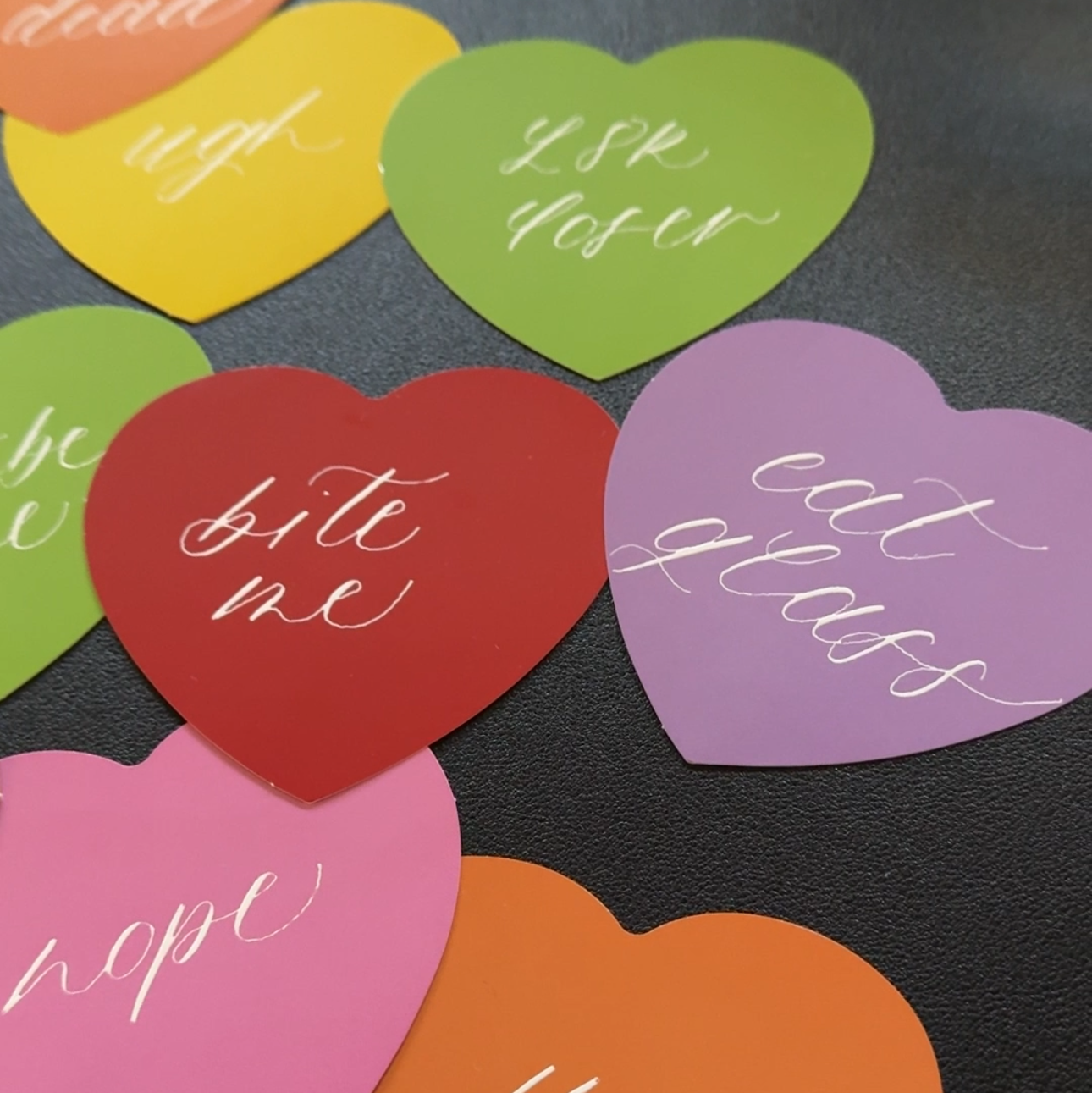 Colorful heart-shaped paper with text on a black background