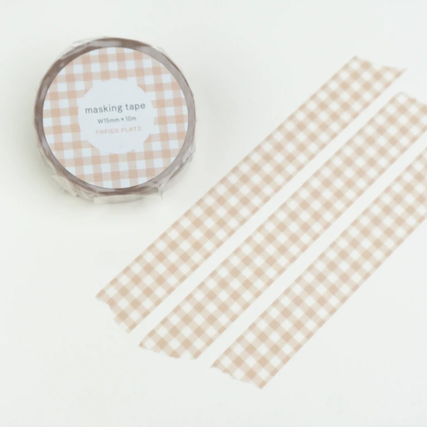 Checkered tape roll on a white card with checkered pattern