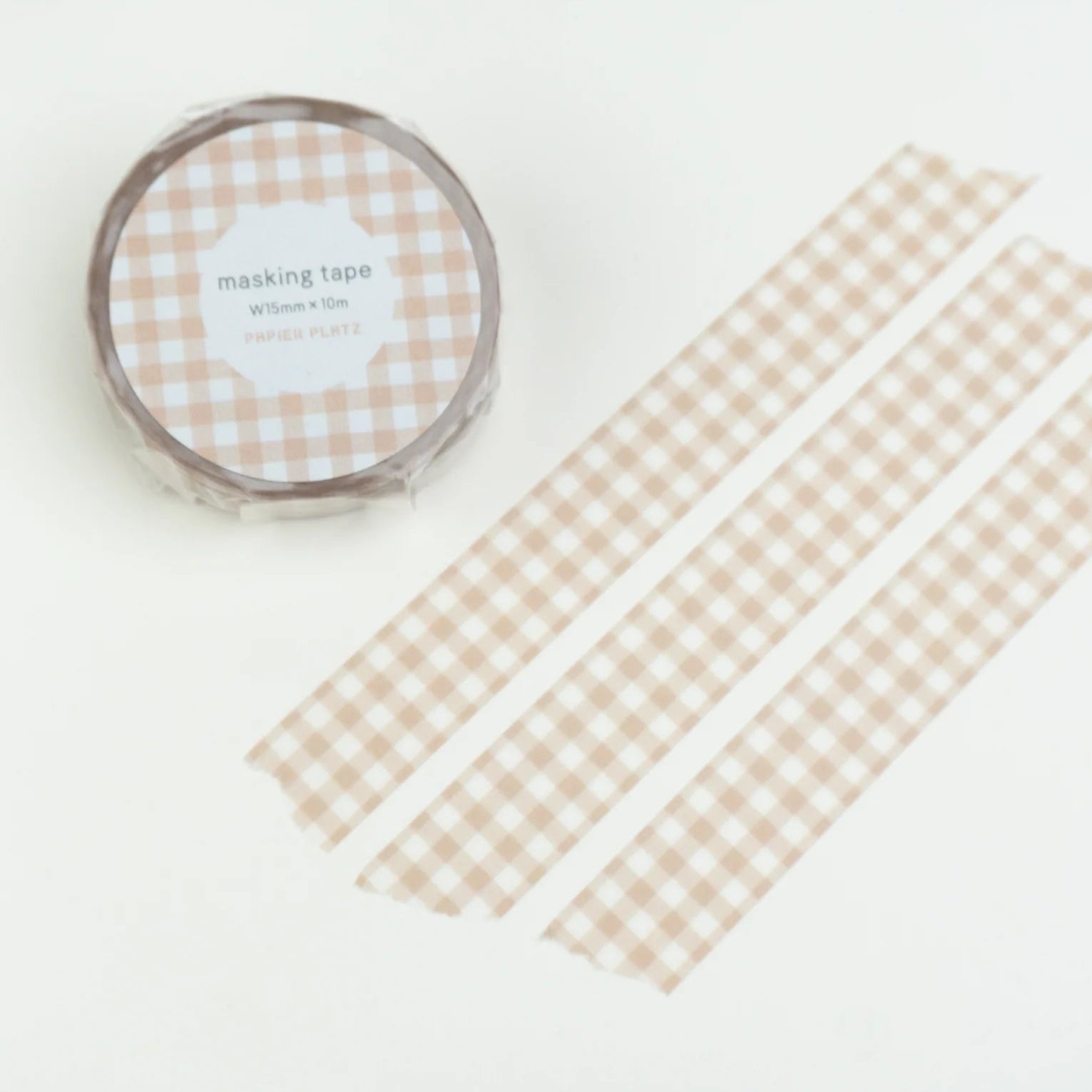 Checkered tape roll on a white card with checkered pattern